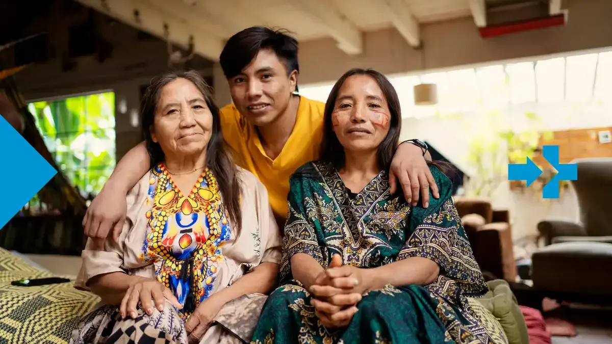 Three generations of a Latin American family celebrating cultural heritage together at home.