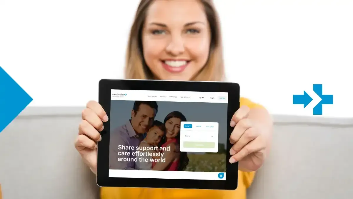 Woman holding a tablet showing sendvalu's new website homepage with a smiling family.