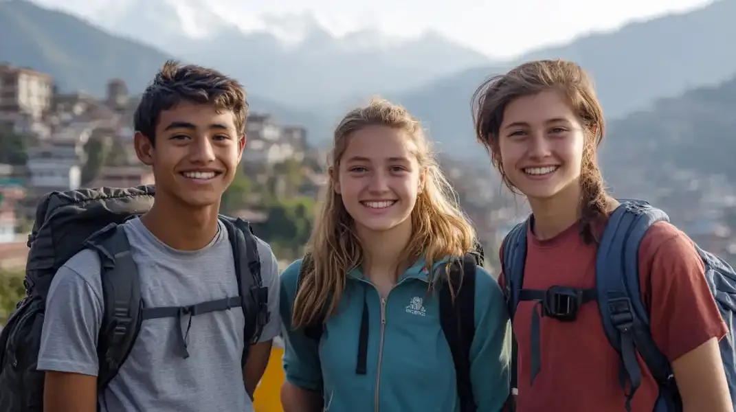Young travelers smiling in the mountains of Nepal, representing celebration and sharing.